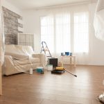 Apartment with nobody in it ready for professional renovation. Plastic sheet. Home during renovation, decoration and painting. Interior apartment improvement maintenance. Roller, ladder for house repair